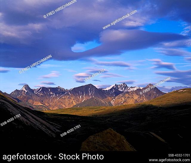 View from Sable Pass of lenticular clouds above peaks of the Alaska Range east of the Teklanika River, Denali National Park, Alaska