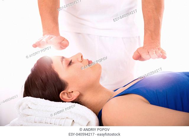 Close-up Of A Relaxed Young Woman Having Reiki Healing Treatment