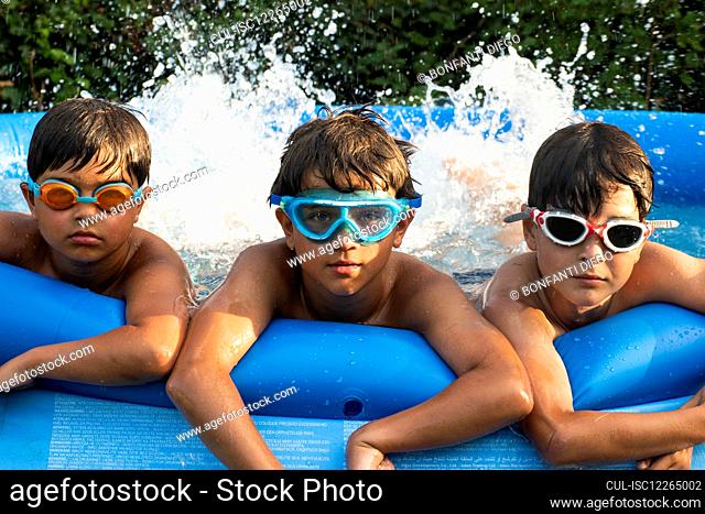 Boys in swimming pool, wearing goggles