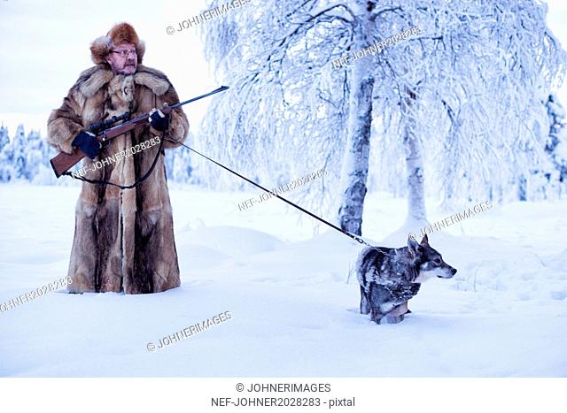 Mature man walking dog at winter