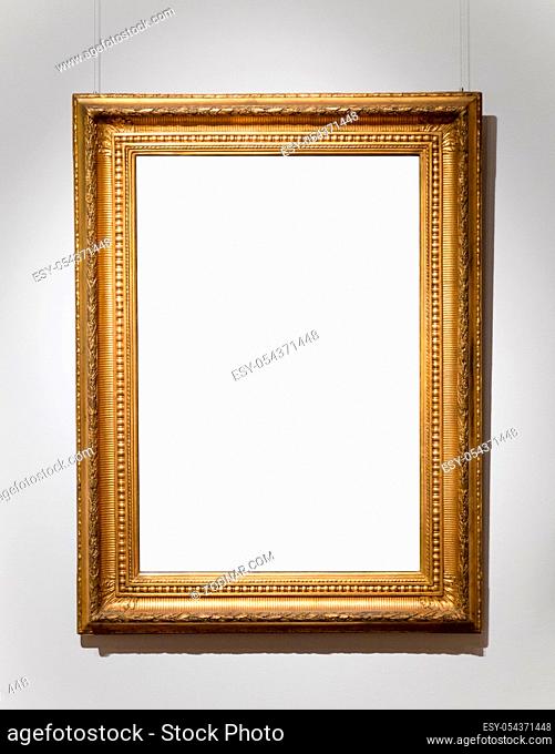 Golden antique empty frame on white wall
