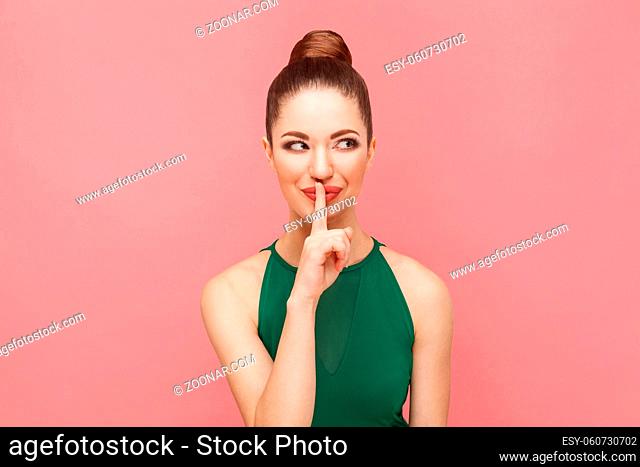 Big secret. Beautiful woman little smiling, telling secret. Expression emotion and feelings concept. Studio shot, isolated on pink background