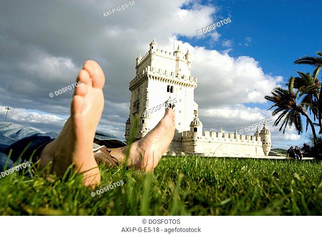 Feet of tourist relaxing in front of Belem Tower