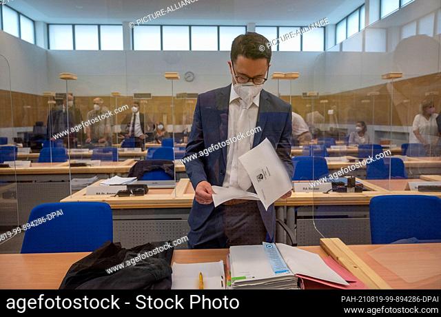 19 August 2021, Rhineland-Palatinate, Trier: Senior public prosecutor Eric Samel stands in the courtroom of Trier Regional Court before the trial and looks...