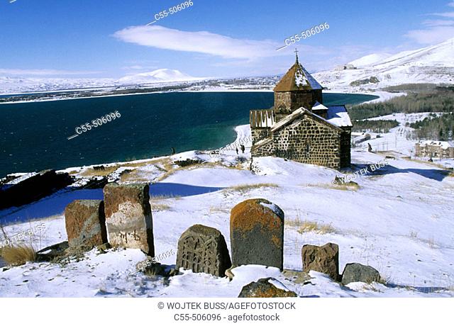Khachkars and Church of the Apostles (monastery founded in 874 A.D) overlooking Lake Sevan. Armenia