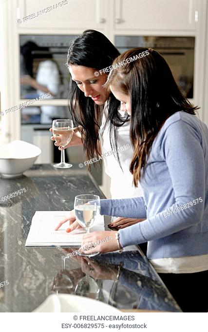 Two friends looking at recipes