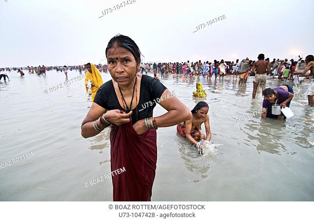 A Hindu pilgrim coming out of the holy water of Gangasagar, west Bengal, India