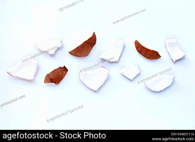 Coconut pieces on white background. Top view of tropical fruit