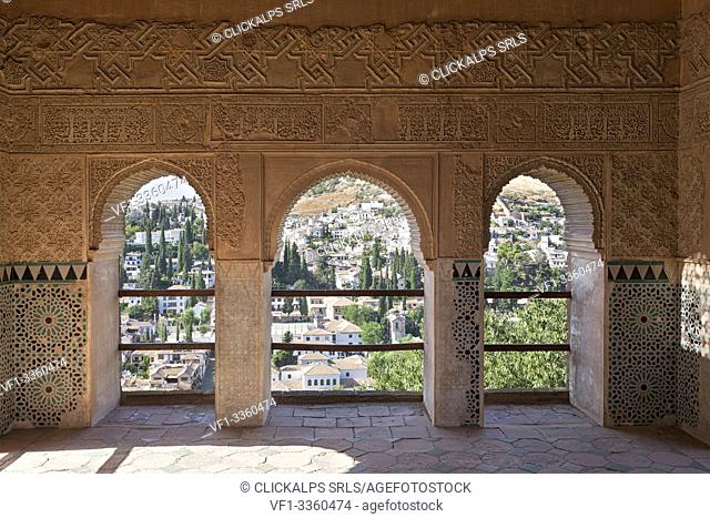 The arabic aeches of Alhambra, with the houses of Albaicín neighborhood in the background, Granada, province of Granada, Andalusia, Spain