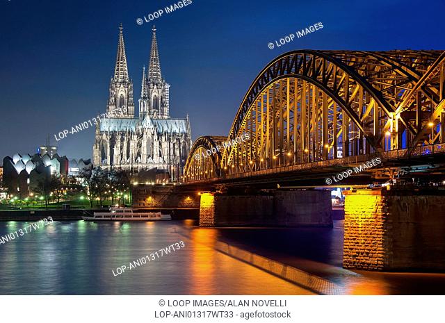 Cologne Cathedral with the Hohenzollern bridge and River Rhine at night
