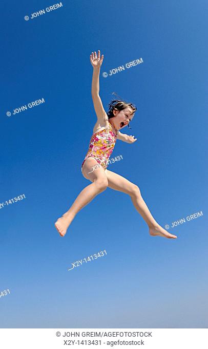 Jouful girl jumping, Ocean City, New Jersey, USA