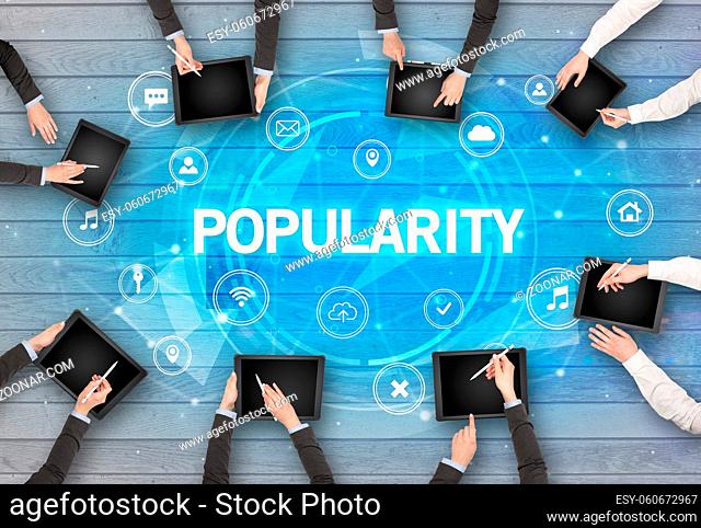 Group of people having a meeting with POPULARITY insciption, social networking concept