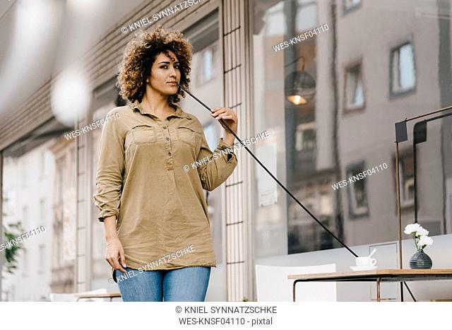 Woman drinking coffee with oversized straw