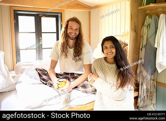 Portrait happy young couple relaxing in cabin