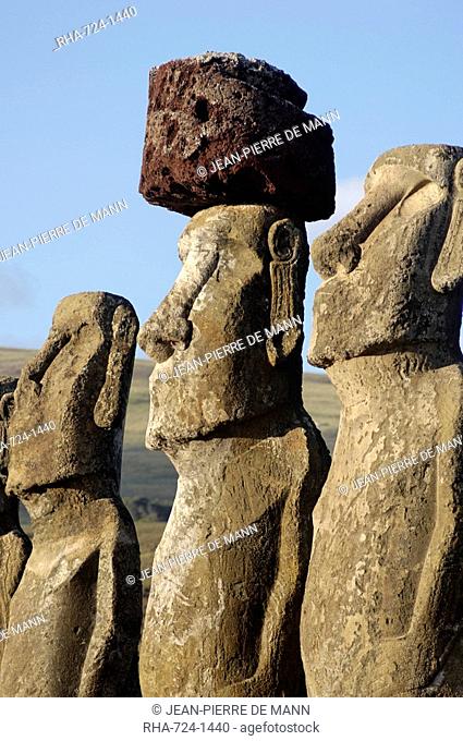 Three of the fifteen huge moai statues standing with their backs to the ocean, restored by archaeologists after destruction in 1960 by a tidal wave