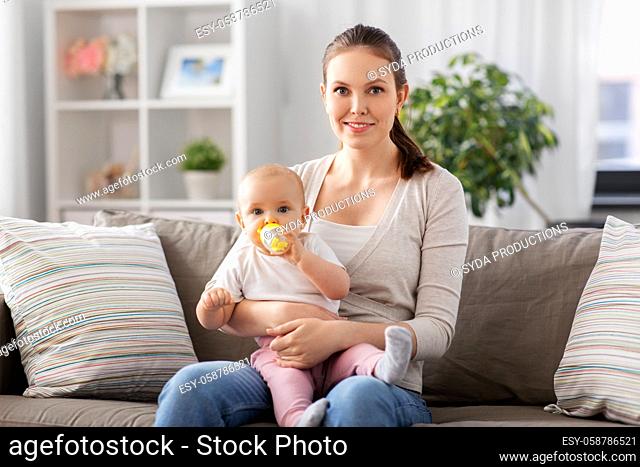 close up of mother with baby drinking water