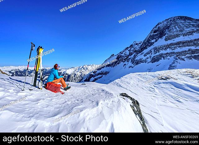 Austria, Tyrol, Female skier taking break at Torhelm mountain