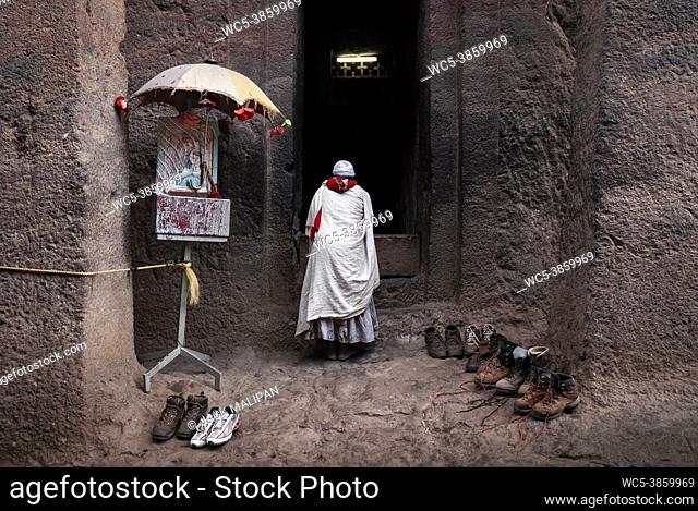 coptic orthodox pilgrim at lalibela ancient rock-hewn monolithic churches landmark UNESCO heritage site in ethiopia