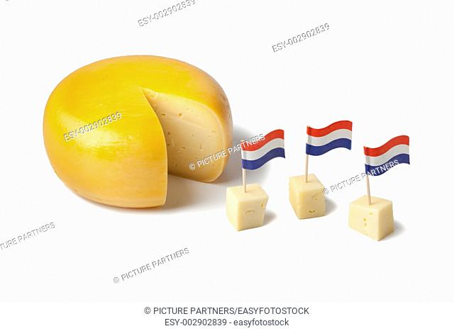 Gouda cheese with dutch flags on white background