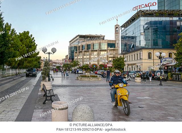 26 October 2018, Albania, Shkodra: Street scene with modern hotels and the Franciscan church in the background. Photo: Peter Endig/dpa-Zentralbild/ZB