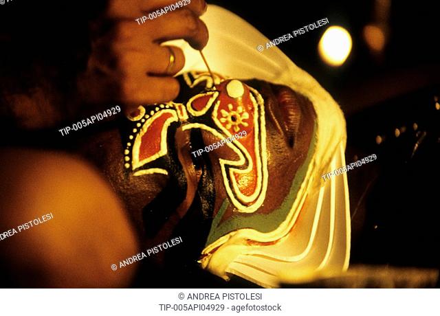 India, Cochin, A Kathakali actor getting make-up for a performance