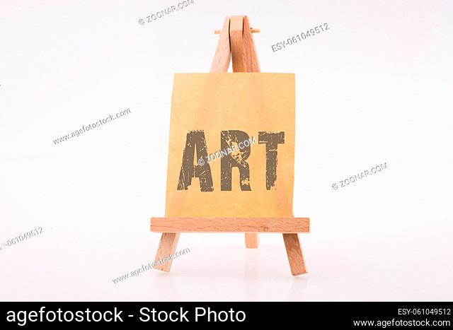 Art wording on brown color notepaper on a painting tripod