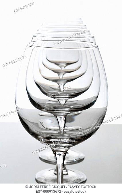Six empty wine glasses lined