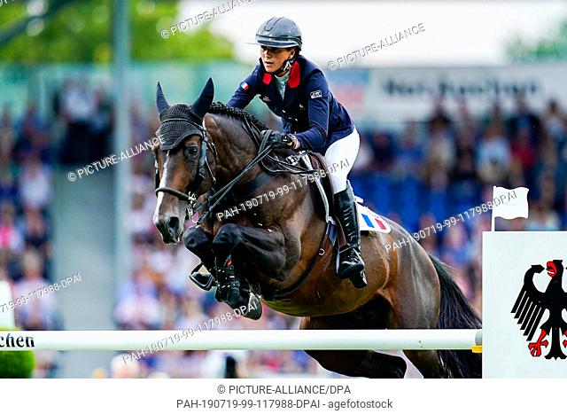 18 July 2019, North Rhine-Westphalia, Aachen: CHIO, equestrian sports, jumping: French show jumper Penelope Leprevost on horse Vancouver de Lanlore jumps over...