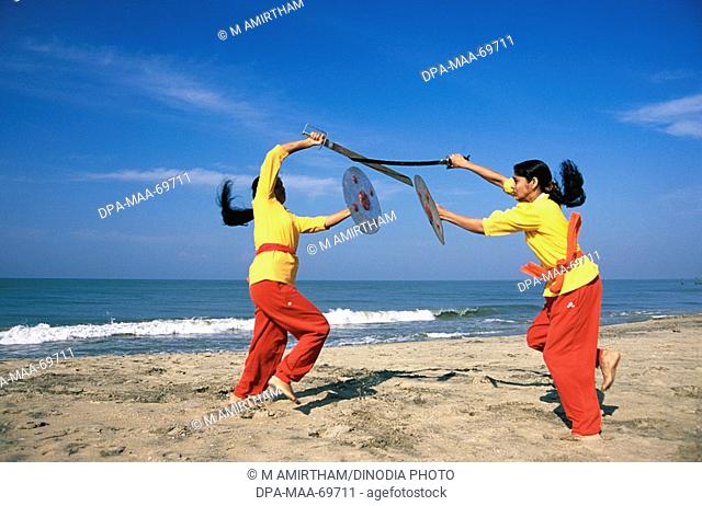 Kalaripayattu ancient martial art of Kerala showing sword and shield fighting at beach