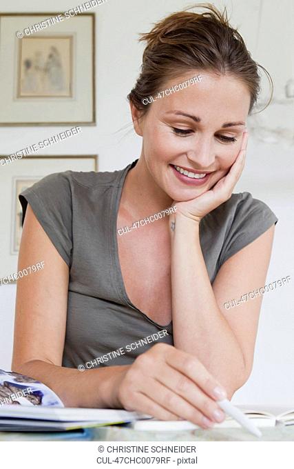 Smiling woman writing at desk