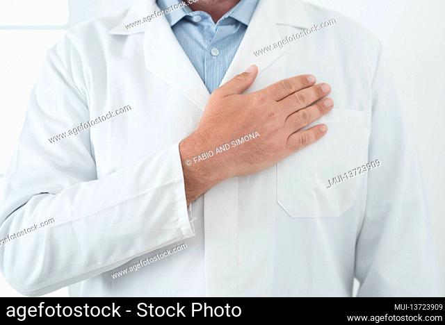 Unrecognizable man doctor portrait with man on heart - cardiologist professional job in white studio - prevention and healthcare concept therapy - healthy...
