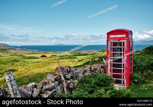 Remote vintage original red British telephone box and view of the Atlantic Ocean, Ardnamurchan Peninsula, Lochaber, Highland, Scotland