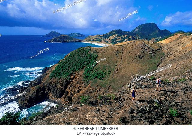 Two hikers above the coast, Anse a Cointe, Iles des Saintes, Guadeloupe, Caribbean, America
