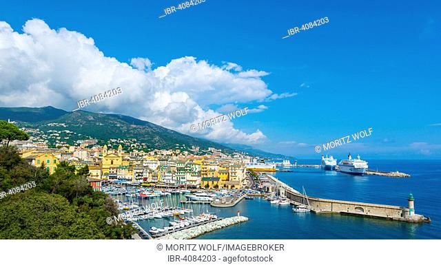 Overview of the old town, the old harbor and the new ferry terminal with the church of Saint-Jean-Baptiste, Bastia, Corsica, France