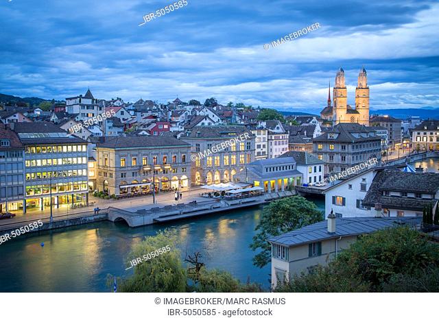 View of the old town at dusk, church Grossmünster at the back, Limmatquai at the river Limmat in front, Zurich, Switzerland, Europe