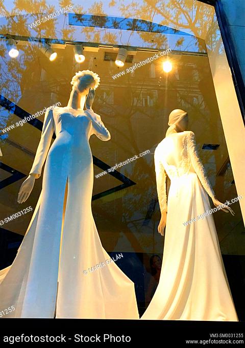 Two mannequins wearing wedding dresses in a shop window. Madrid, Spain