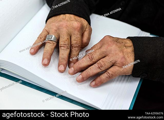 RUSSIA, GROZNY - OCTOBER 3, 2023: A man reads a book written in Braille during a class for the blind and visually impaired at a madrassa named after Magomed...