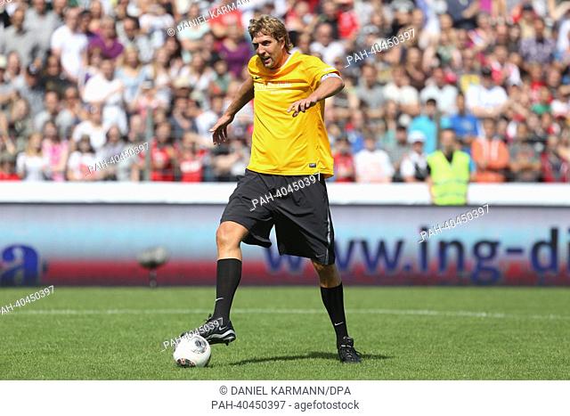 Professional basketball player Dirk Nowitzk plays the ball during the charity soccer match between 'Manuel Neuer & Friends' and 'Nowitzki Allstars' in Wuerzburg