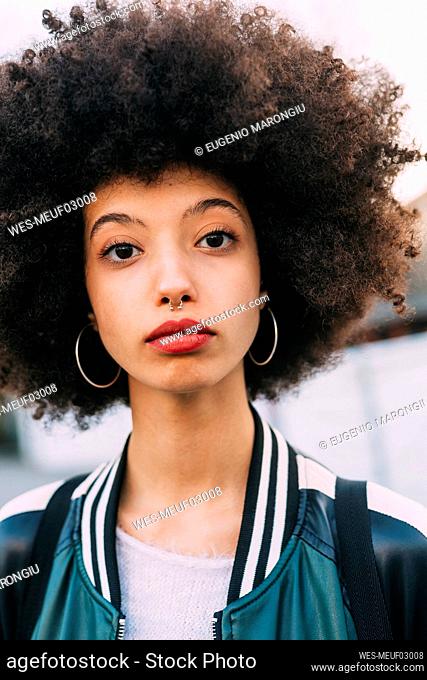 Young afro hair woman staring with blank expression
