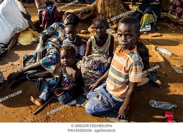 A family sits on the grounds of St. Theresa cathedral after having fled from the fights in the capital between the soldiers of the SPLA (Sudan People Liberation...