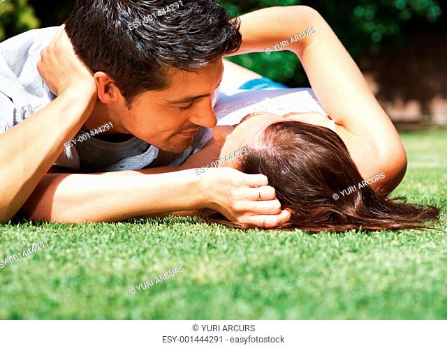 Portrait of a romantic young couple about to kiss each other in the park - Outdoor
