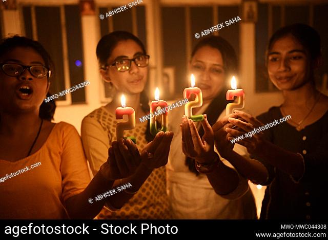 Tripura, India. 1st January 2022. Students of ""Manjari Dance Academy"" light candles highlighting 2022 to welcome the New Year in Agartala