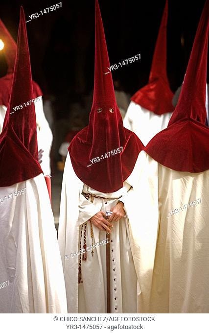 Penitents walk in the Orange Trees Court, Patio de los Naranjos in Spanish, in the Mosque-Cathedral of Cordoba during Easter Holy Week celebrations in Cordoba