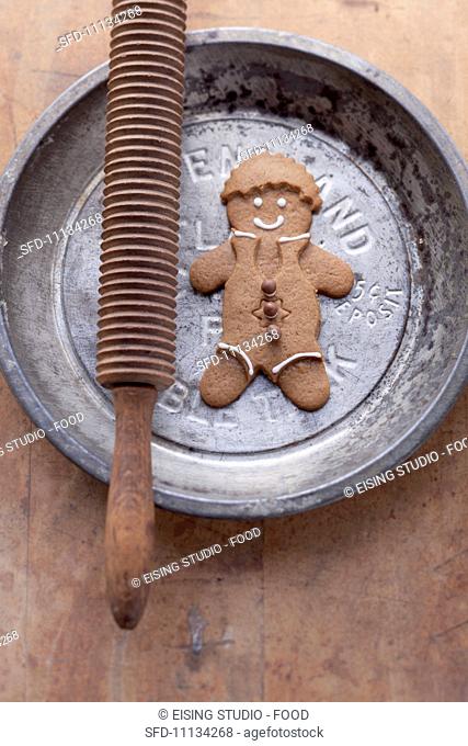 A gingerbread man on a metal plate