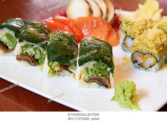 Various types of sushi on a serving platter (close-up)