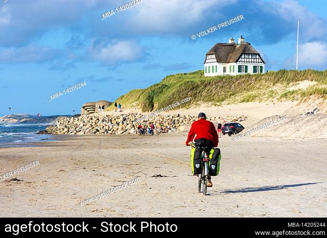 Hjoerring, beach, sea, half-timbered thatched roof house, cyclists, WWII bunker, built during the German occupancy in Loekken, Jylland, Jutland, Denmark