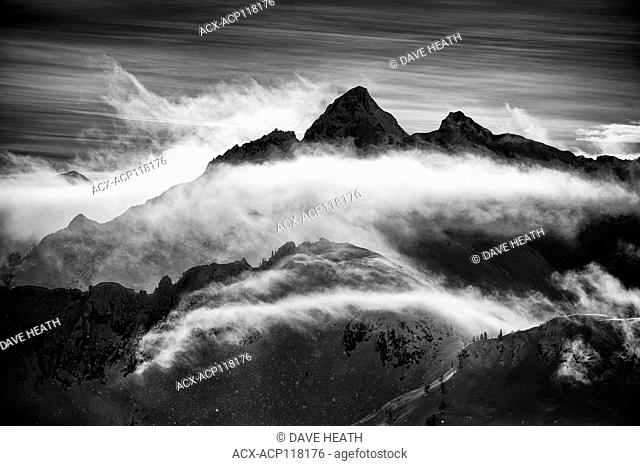 Mount Harlow with cloud veil in Black and white in the Valhalla Mountain range, BC, Canada, Winter