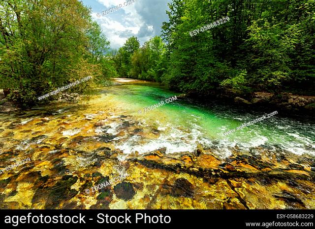 Colorful spring panorama of Sava bohinjka river at the Bohinj Lake village Ukanc. Picturesque moning scene in the Triglav National Park, Julian Alps