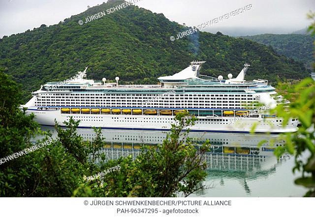The cruise ship ""Explorer of the Seas"" passes the fjord landscape of the Marlborough Sounds near harbor of Picton on the South Island of New Zealand