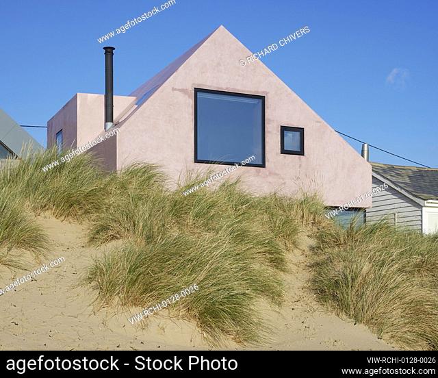 Aerial shot of house with view along beach. Seabreeze, Camber, United Kingdom. Architect: RX Architects, 2022
